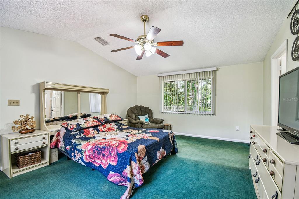 9741 Star Trail New Port Richey, FL 34654 - Photo 29 of 38 a bedroom with a bed and a chandelier