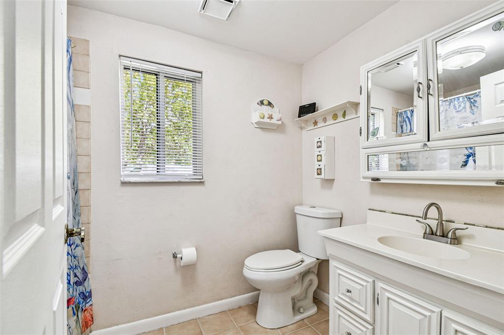 9741 Star Trail New Port Richey, FL 34654 - Photo 30 of 38 a bathroom with a sink a toilet and a mirror
