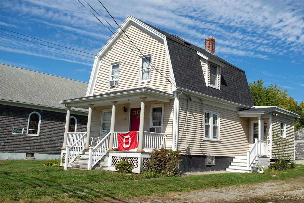 1261 G A R Highway Swansea, MA 02777 - Photo 5 of 25 a front view of a house with a yard and garage