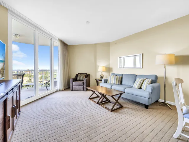 a living room with furniture a rug and a lamp