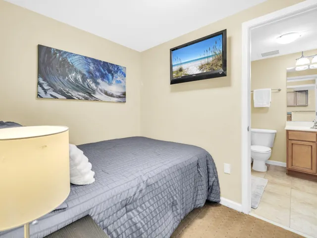 a bedroom with a bed and a painting on the wall
