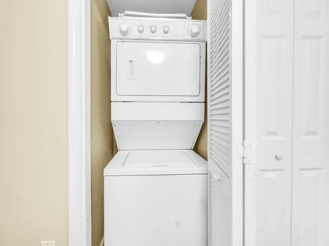a bathroom with a granite countertop sink mirror vanity and toilet
