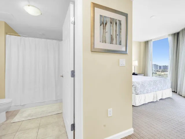 a bedroom with a bed and a large window