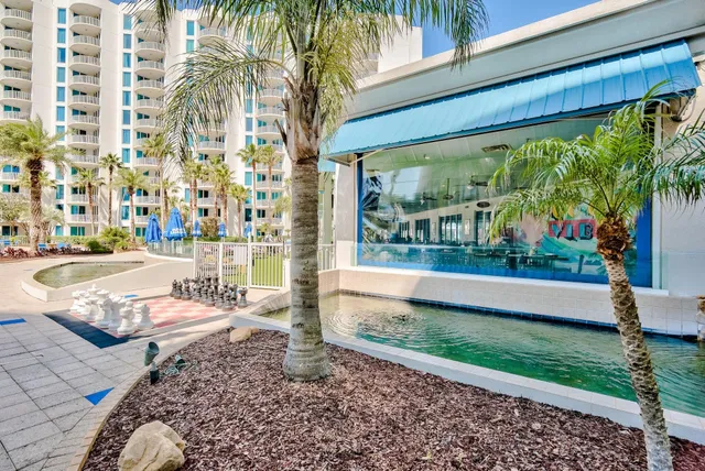 a swimming pool with outdoor seating and yard