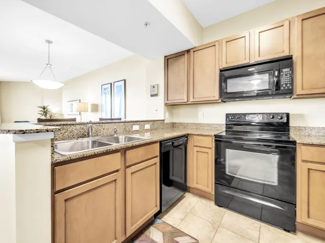 a kitchen with stainless steel appliances granite countertop a stove and cabinets