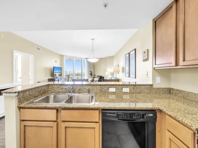 a view of a dining room with furniture and a chandelier