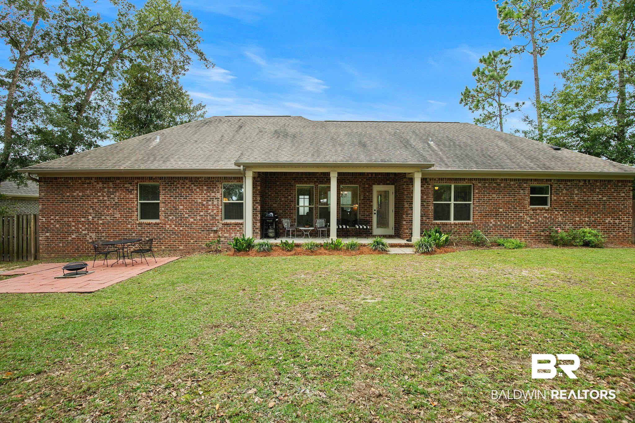 19740 Bunker Loop Fairhope, AL 36532 - Photo 30 of 33 Rear view of house with a patio, roof with shingles, and brick siding
