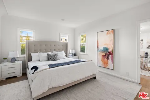 a bed room with a bed and a painting