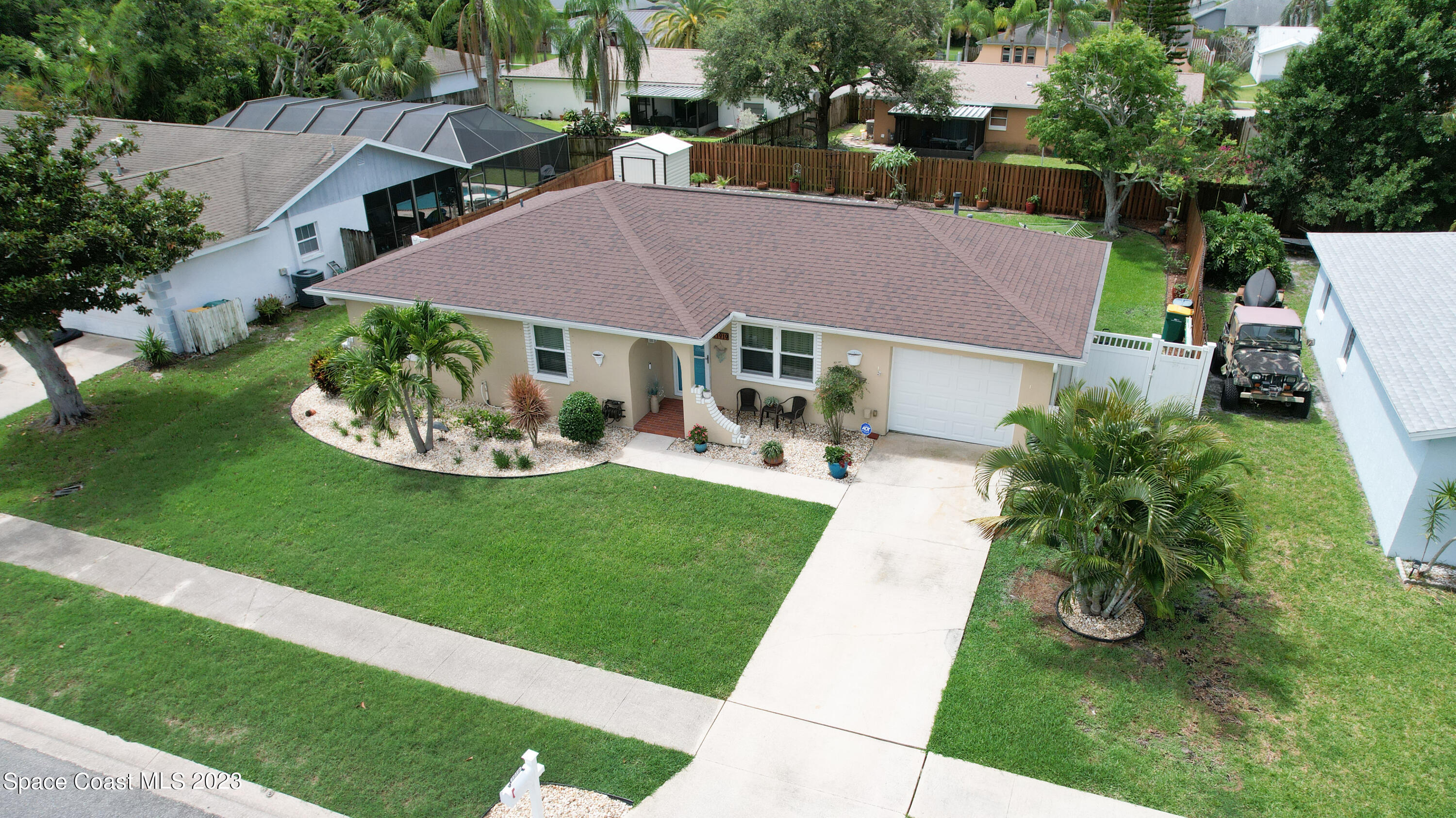 a view of house with garden space and a street view