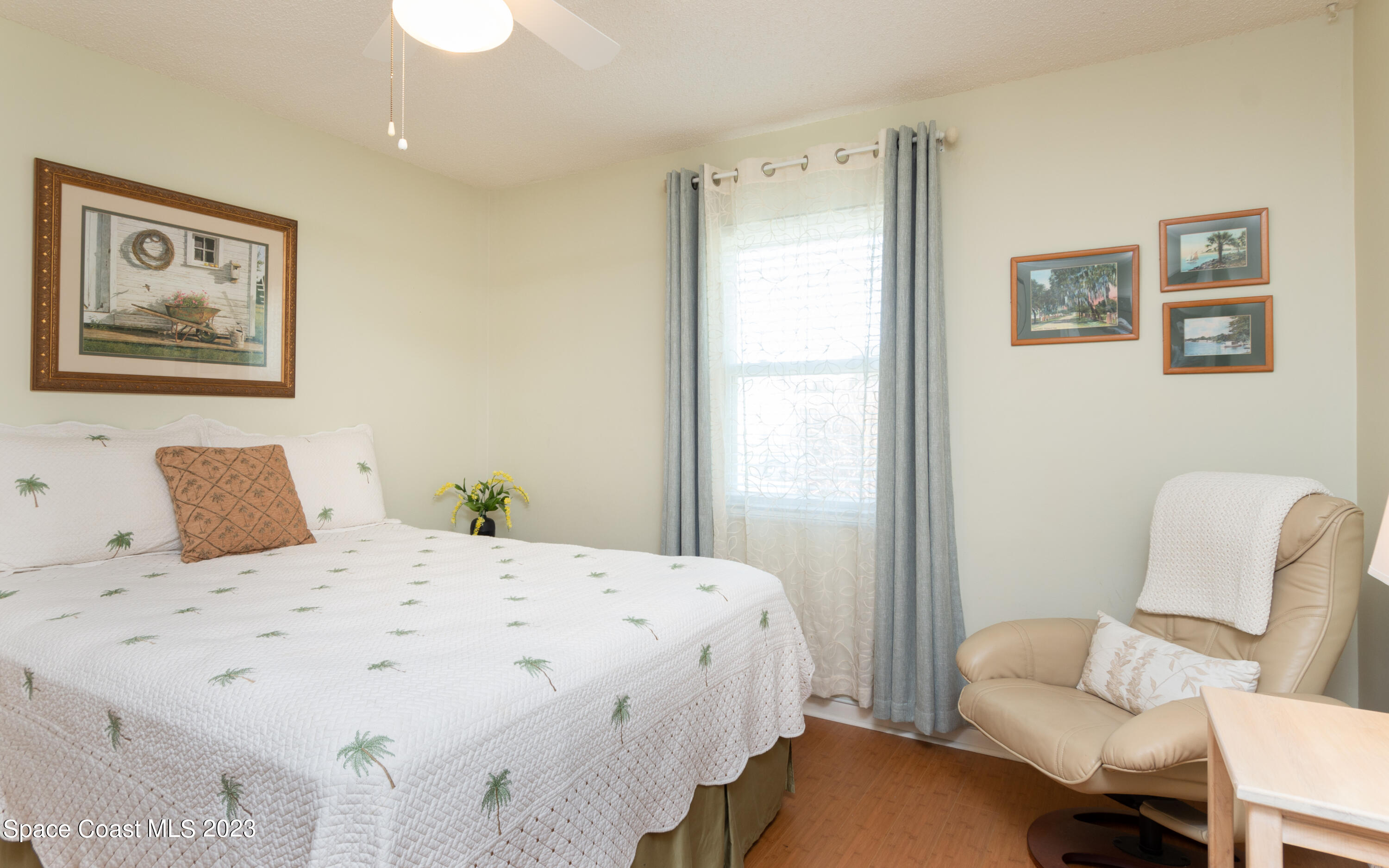 1919 Player Circle North Melbourne, FL 32935 - Photo 11 of 29 a bedroom with a bed and a couch