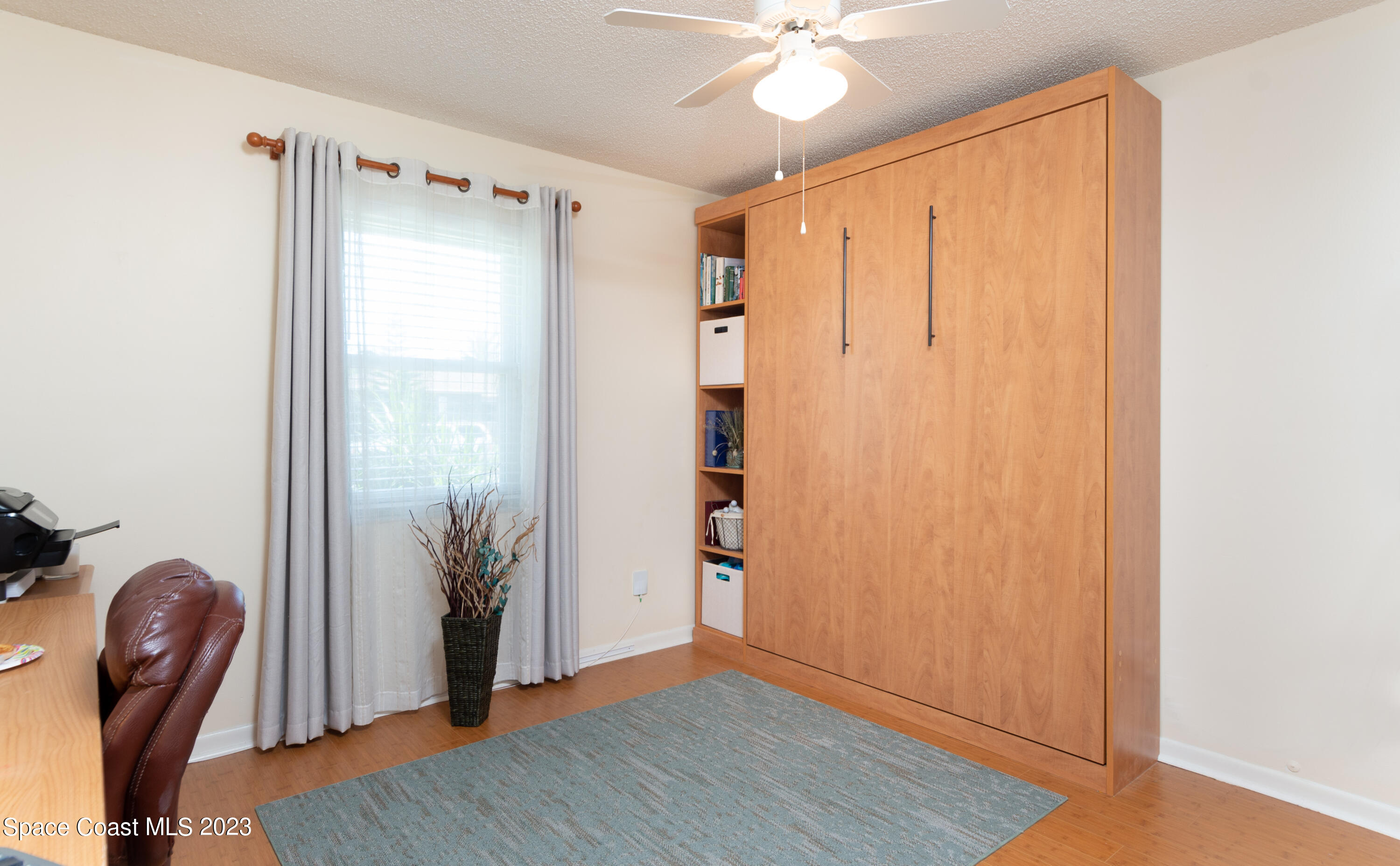 1919 Player Circle North Melbourne, FL 32935 - Photo 12 of 29 a view of a room with furniture and wooden floor