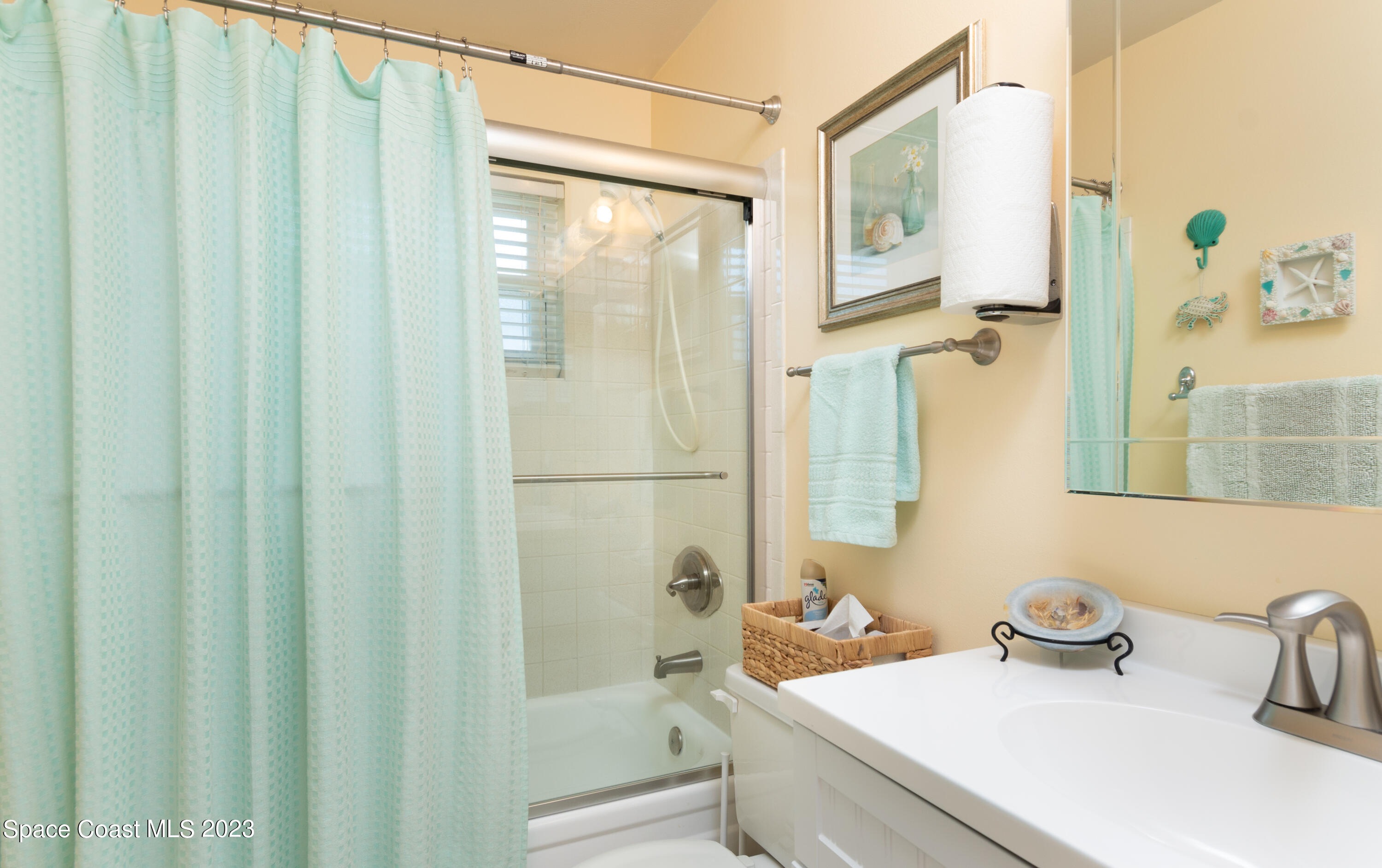 1919 Player Circle North Melbourne, FL 32935 - Photo 14 of 29 a bathroom with a sink a toilet and shower curtain