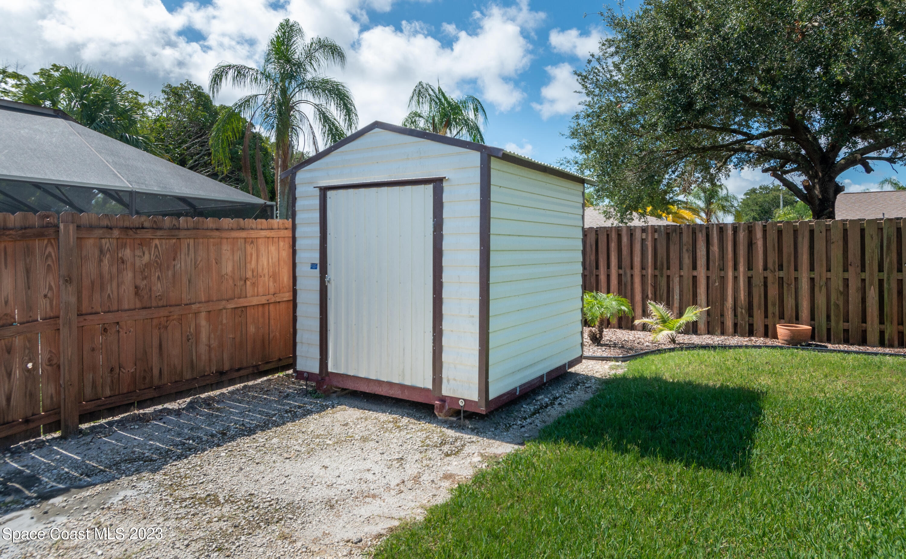1919 Player Circle North Melbourne, FL 32935 - Photo 22 of 29 a view of a backyard with small cabin