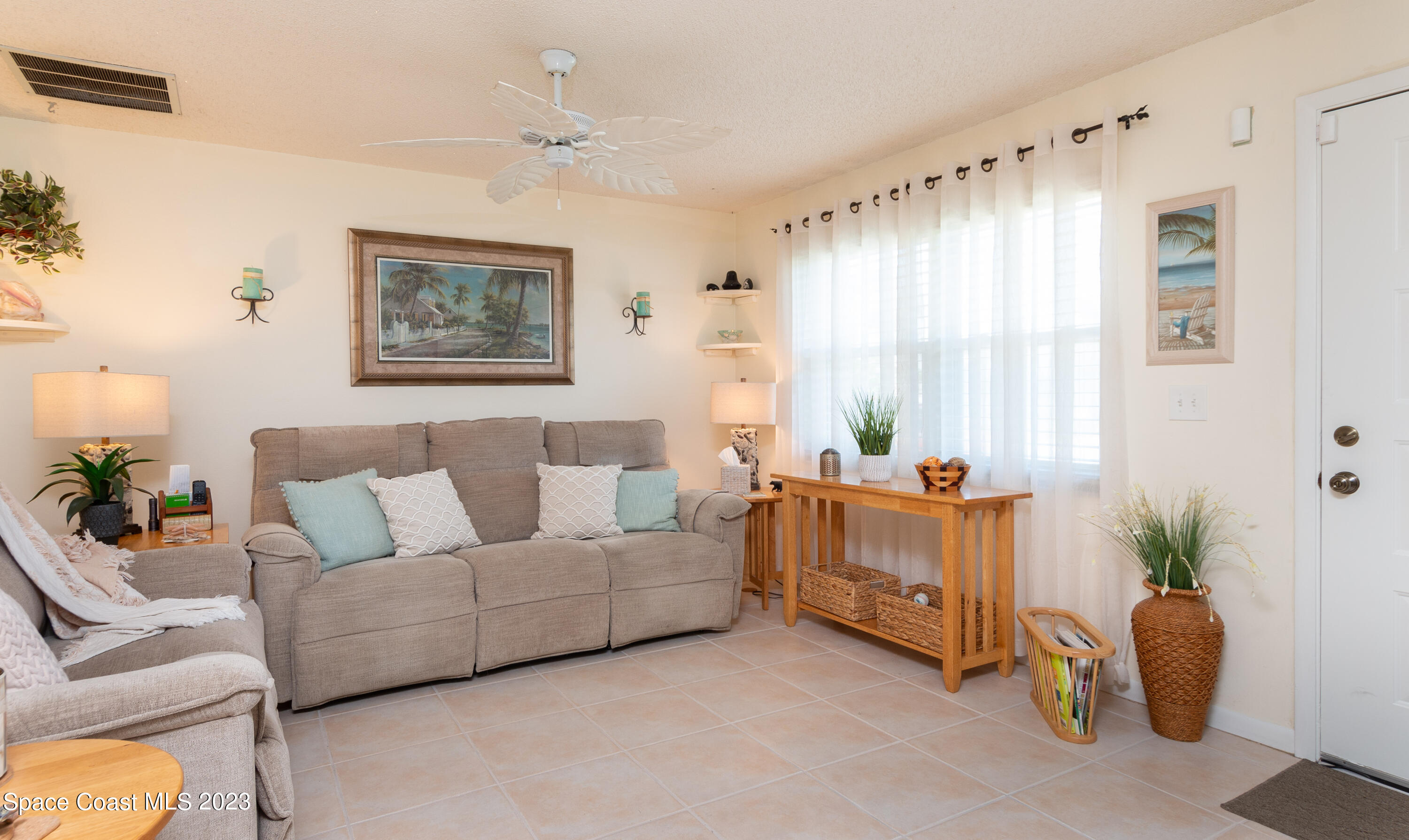 1919 Player Circle North Melbourne, FL 32935 - Photo 4 of 29 a living room with furniture and a large window
