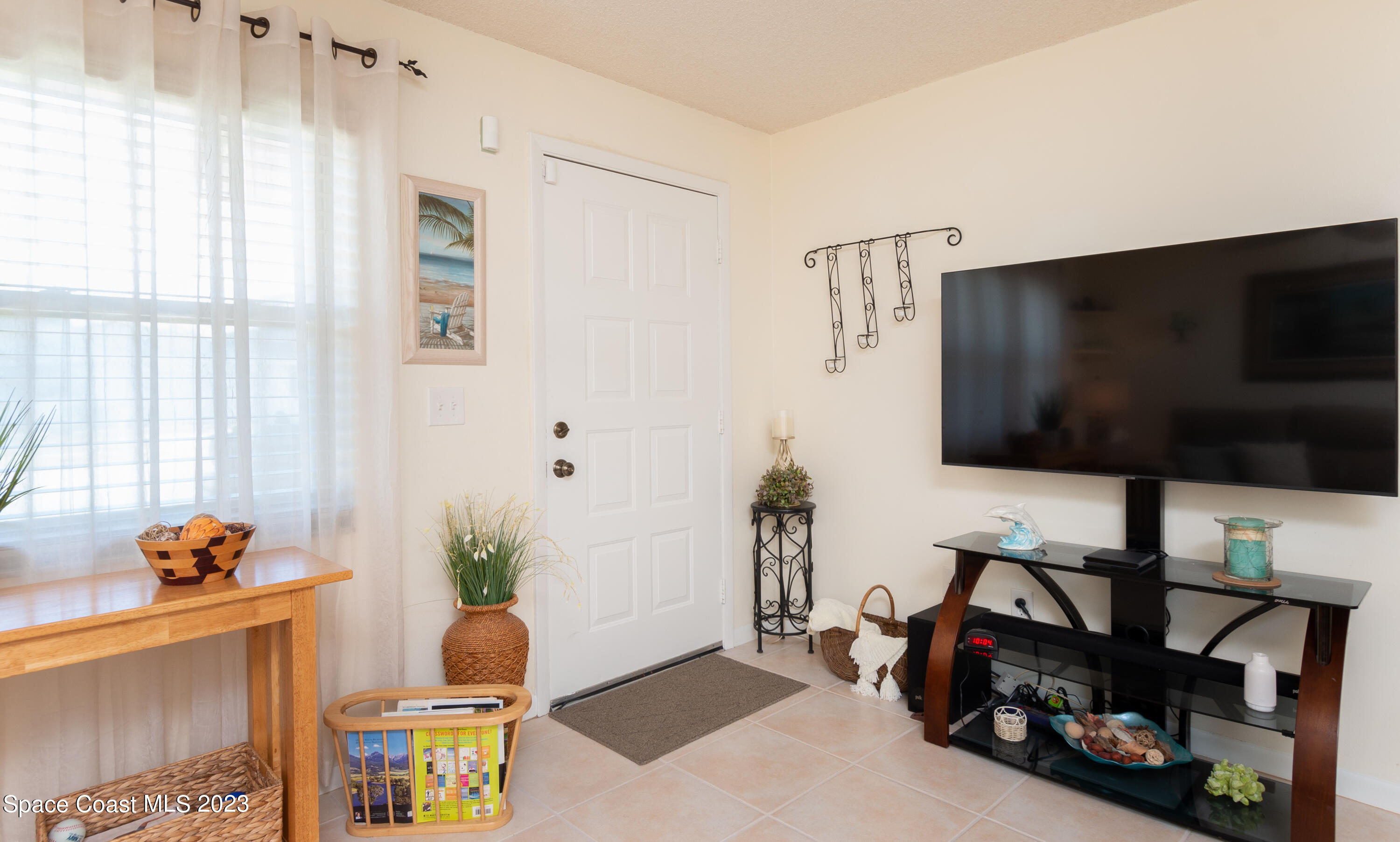 1919 Player Circle North Melbourne, FL 32935 - Photo 6 of 29 a living room with furniture and a flat screen tv