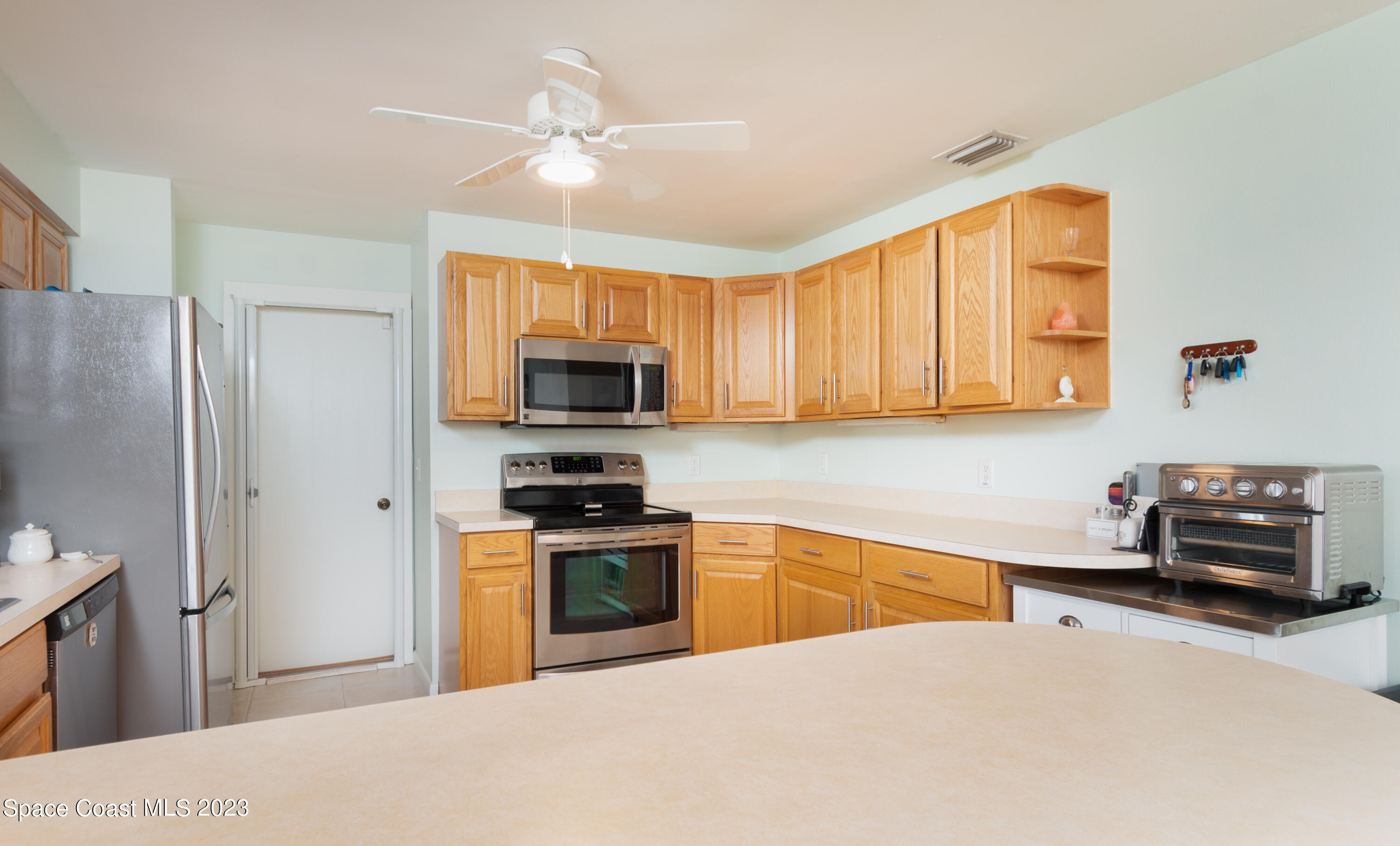 1919 Player Circle North Melbourne, FL 32935 - Photo 7 of 29 a kitchen with stainless steel appliances a stove sink and microwave