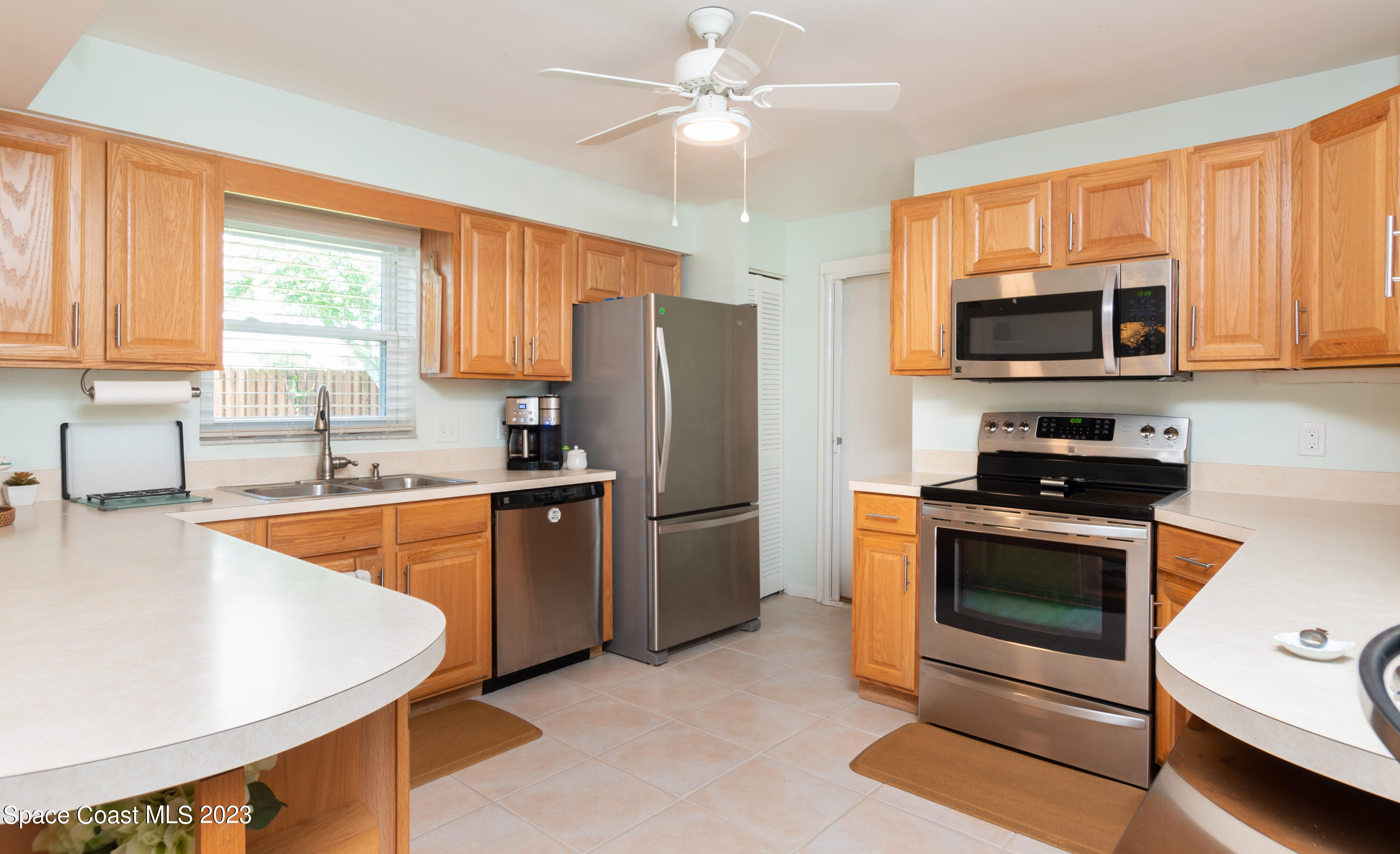 1919 Player Circle North Melbourne, FL 32935 - Photo 8 of 29 a kitchen with stainless steel appliances granite countertop a stove a sink dishwasher a refrigerator and a microwave oven