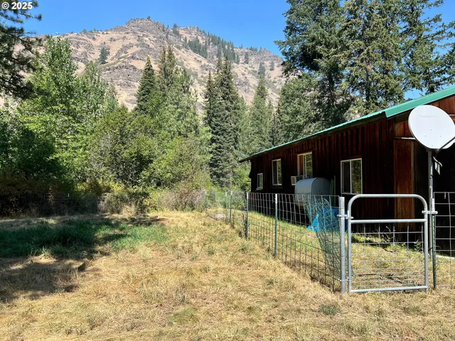 a backyard of a house with basket ball court