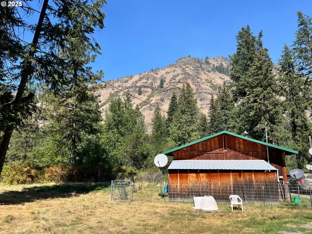 a view of a house with swimming pool next to a yard
