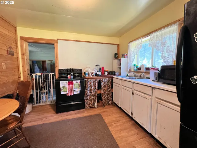 a open kitchen with stainless steel appliances kitchen island granite countertop a sink and cabinets