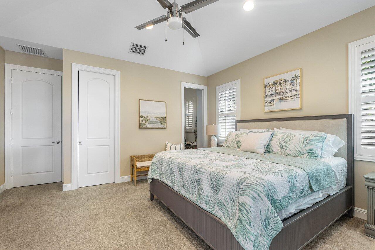 136 Ocean Breeze Drive Juno Beach, FL 33408 - Photo 14 of 30 a bedroom with a bed and window