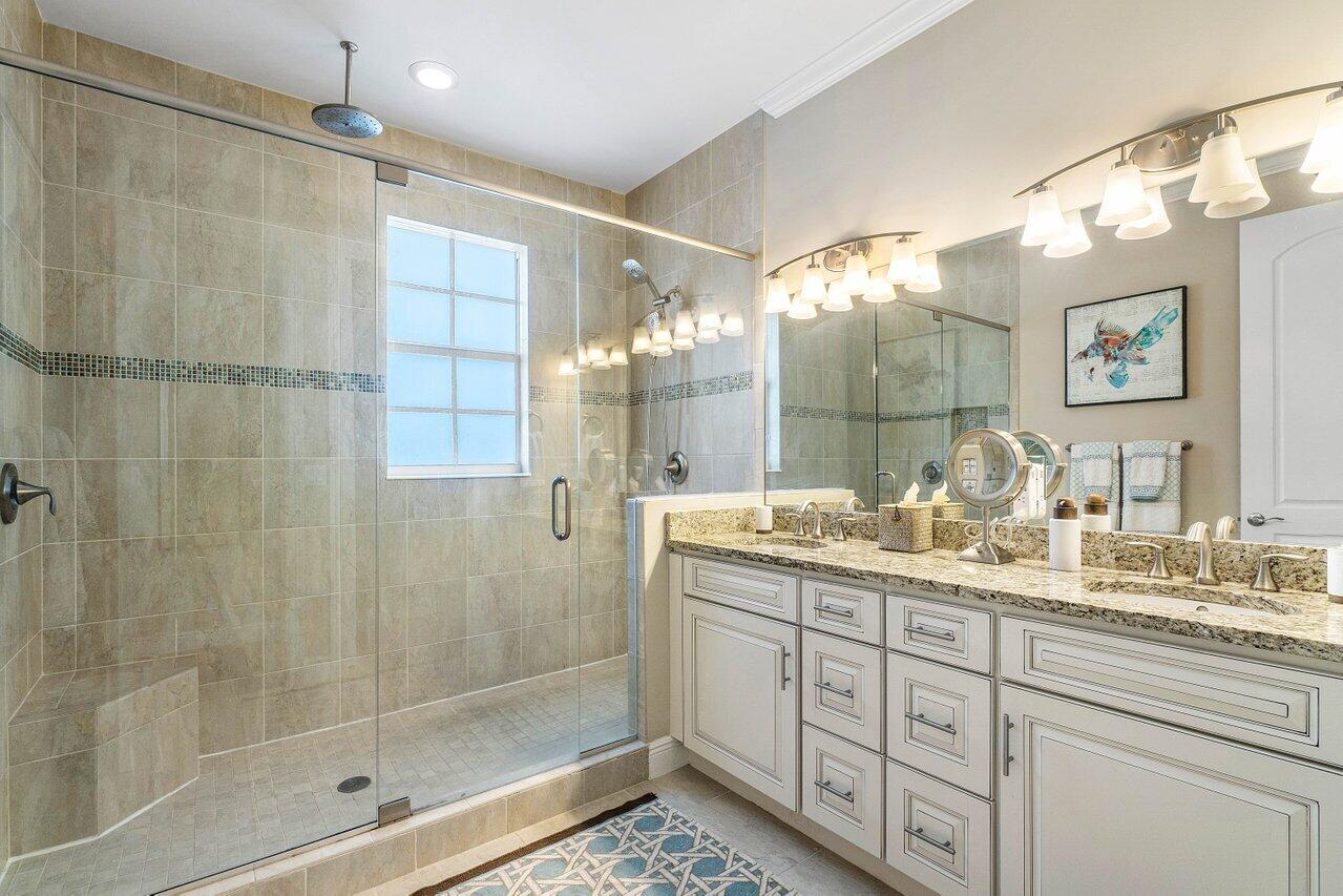 136 Ocean Breeze Drive Juno Beach, FL 33408 - Photo 15 of 30 a bathroom with double vanity and a shower