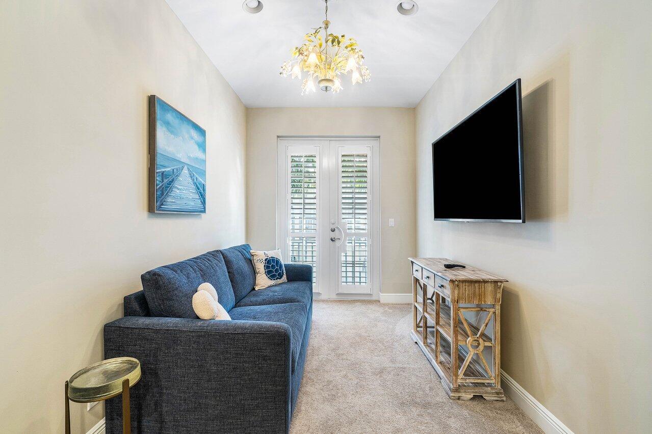 136 Ocean Breeze Drive Juno Beach, FL 33408 - Photo 17 of 30 a living room with furniture and a flat screen tv