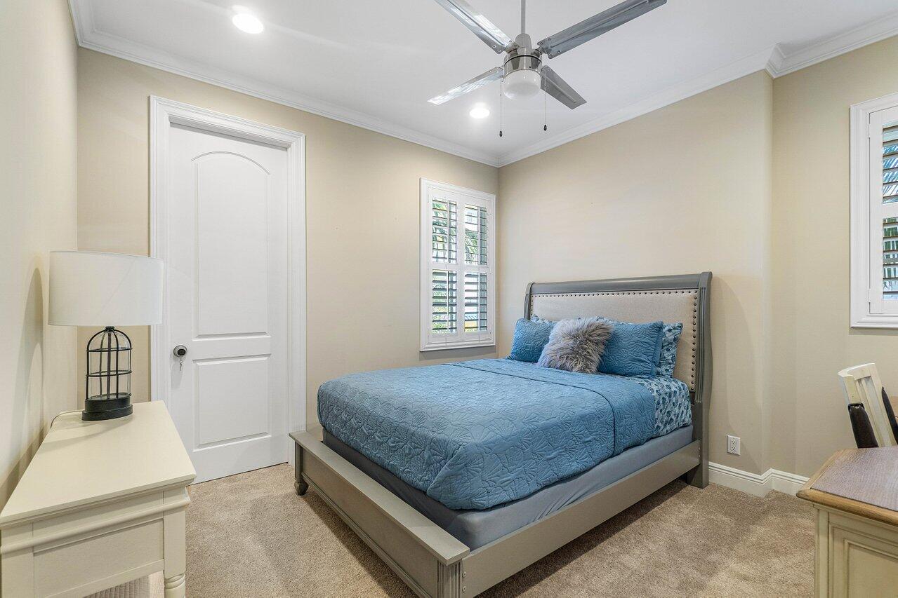 136 Ocean Breeze Drive Juno Beach, FL 33408 - Photo 18 of 30 a bedroom with a bed and a sink