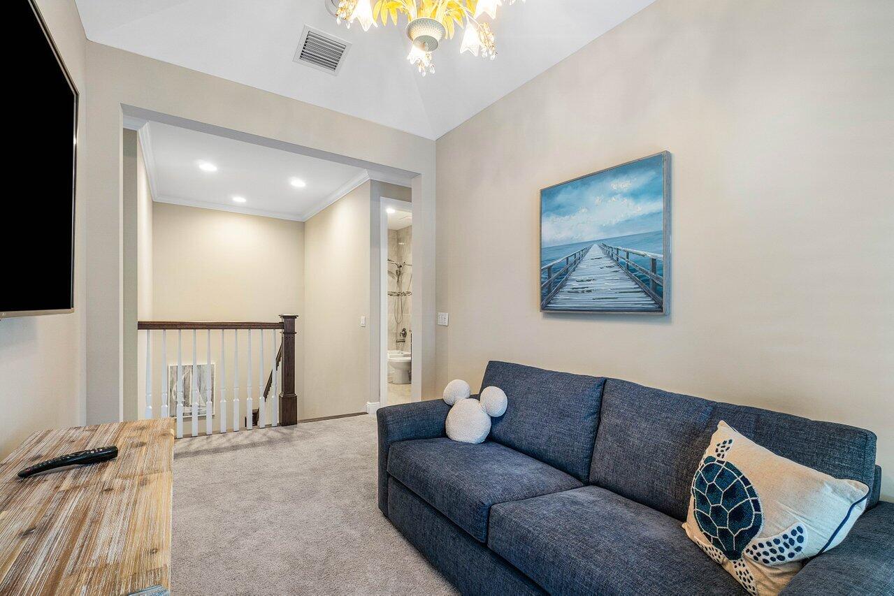 136 Ocean Breeze Drive Juno Beach, FL 33408 - Photo 23 of 30 a living room with furniture and a flat screen tv