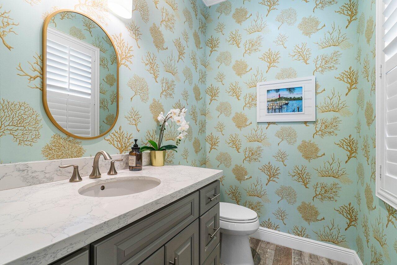 136 Ocean Breeze Drive Juno Beach, FL 33408 - Photo 24 of 30 a bathroom with a sink and a mirror