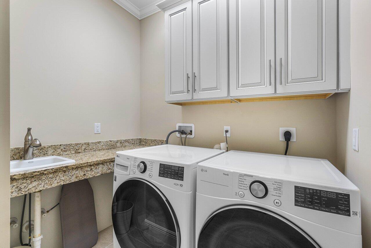 136 Ocean Breeze Drive Juno Beach, FL 33408 - Photo 25 of 30 a utility room with dryer and washer