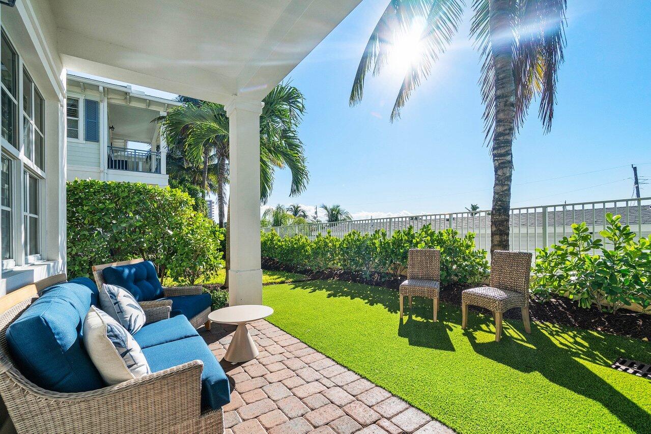 136 Ocean Breeze Drive Juno Beach, FL 33408 - Photo 29 of 30 a view of a patio with couches table and chairs and potted plants