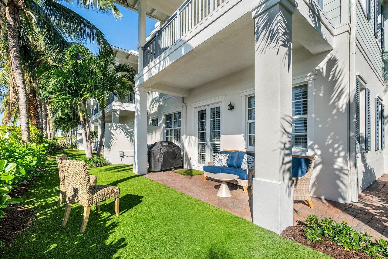 136 Ocean Breeze Drive Juno Beach, FL 33408 - Photo 30 of 30 a view of a patio with table and chairs and potted plants