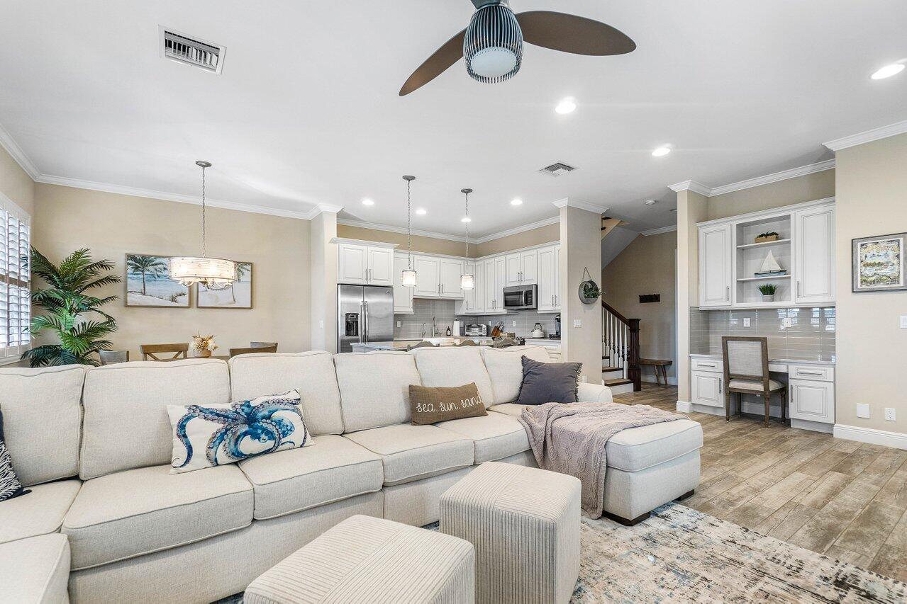 136 Ocean Breeze Drive Juno Beach, FL 33408 - Photo 8 of 30 a living room with furniture kitchen view and a chandelier