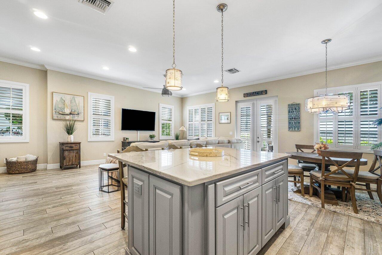 136 Ocean Breeze Drive Juno Beach, FL 33408 - Photo 10 of 30 a kitchen with stainless steel appliances granite countertop a stove and a wooden floors