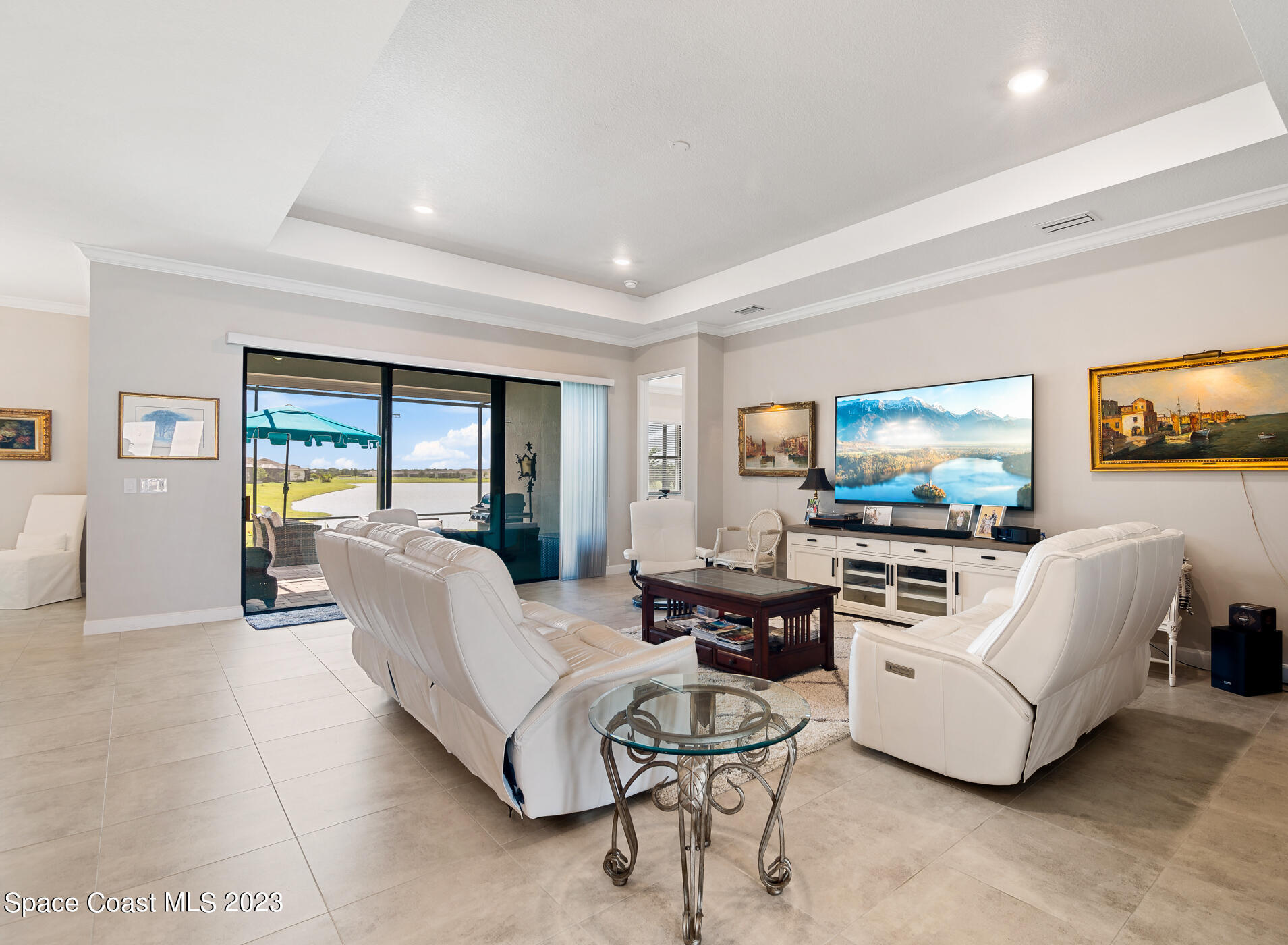 2579 Millennium Circle Melbourne, FL 32940 - Photo 14 of 42 a living room with furniture and a flat screen tv