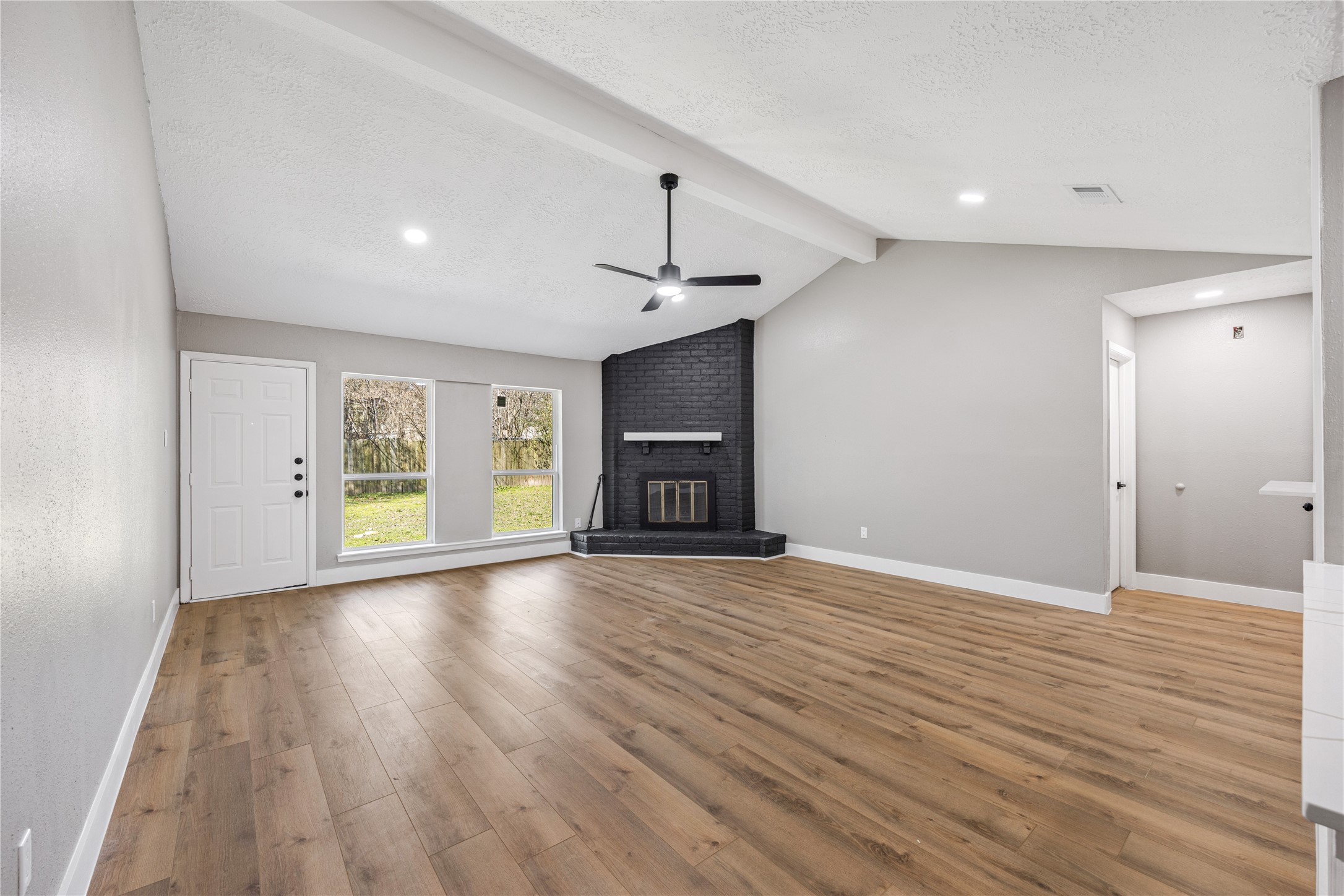 4515 Mossygate Drive Spring, TX 77373 - Photo 12 of 31 a view of an empty room with wooden floor fireplace and a window