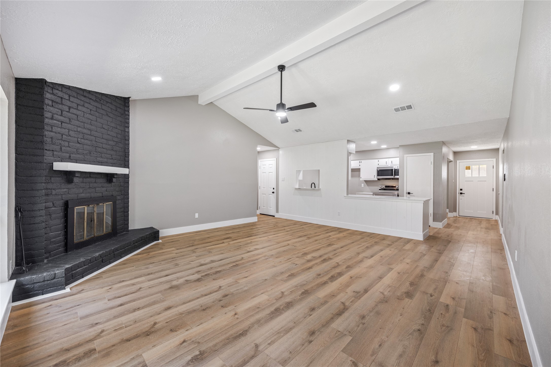 4515 Mossygate Drive Spring, TX 77373 - Photo 13 of 31 a view of empty room with wooden floor and fireplace