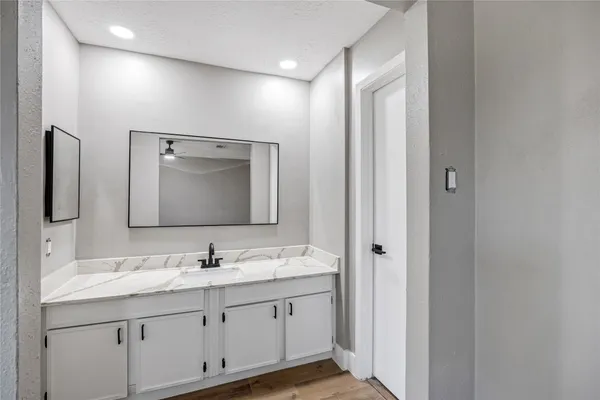 a bathroom with double vanity sink and a mirror