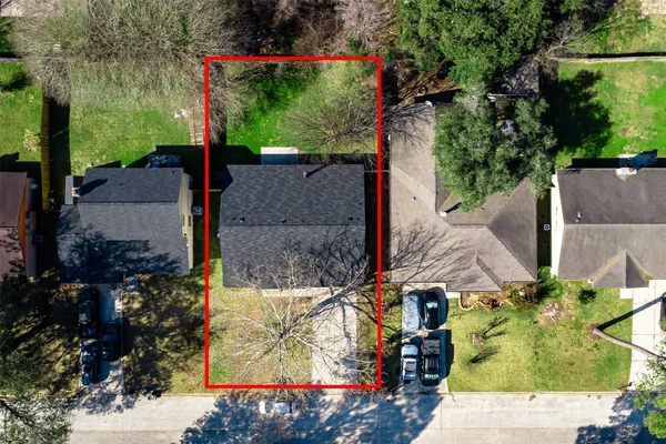 an aerial view of a house with a yard