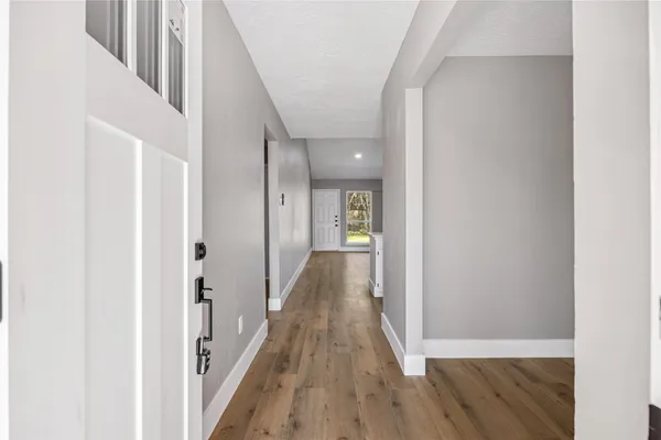 a view of a hallway with wooden floor