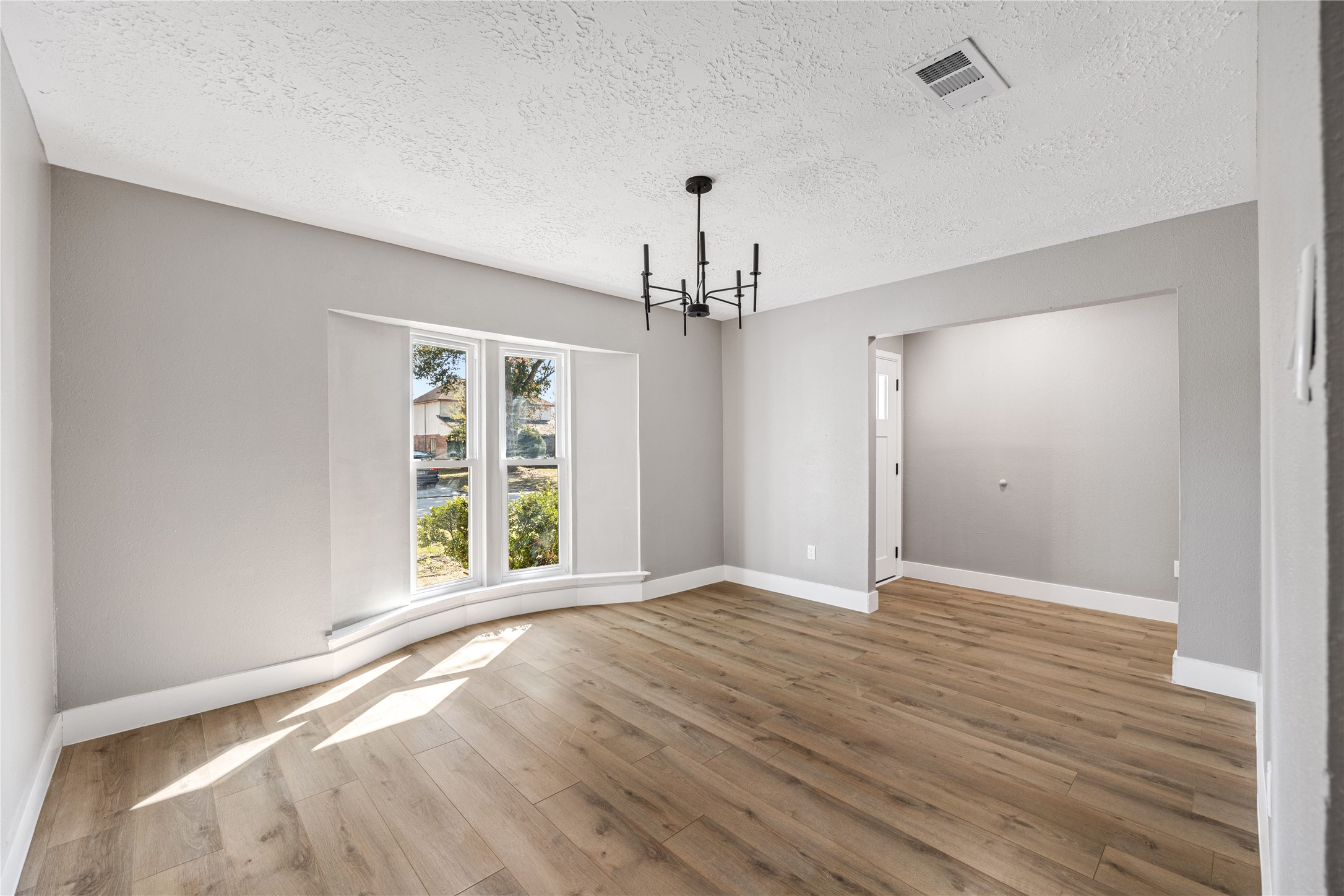 4515 Mossygate Drive Spring, TX 77373 - Photo 5 of 31 a view of an empty room with wooden floor and a window