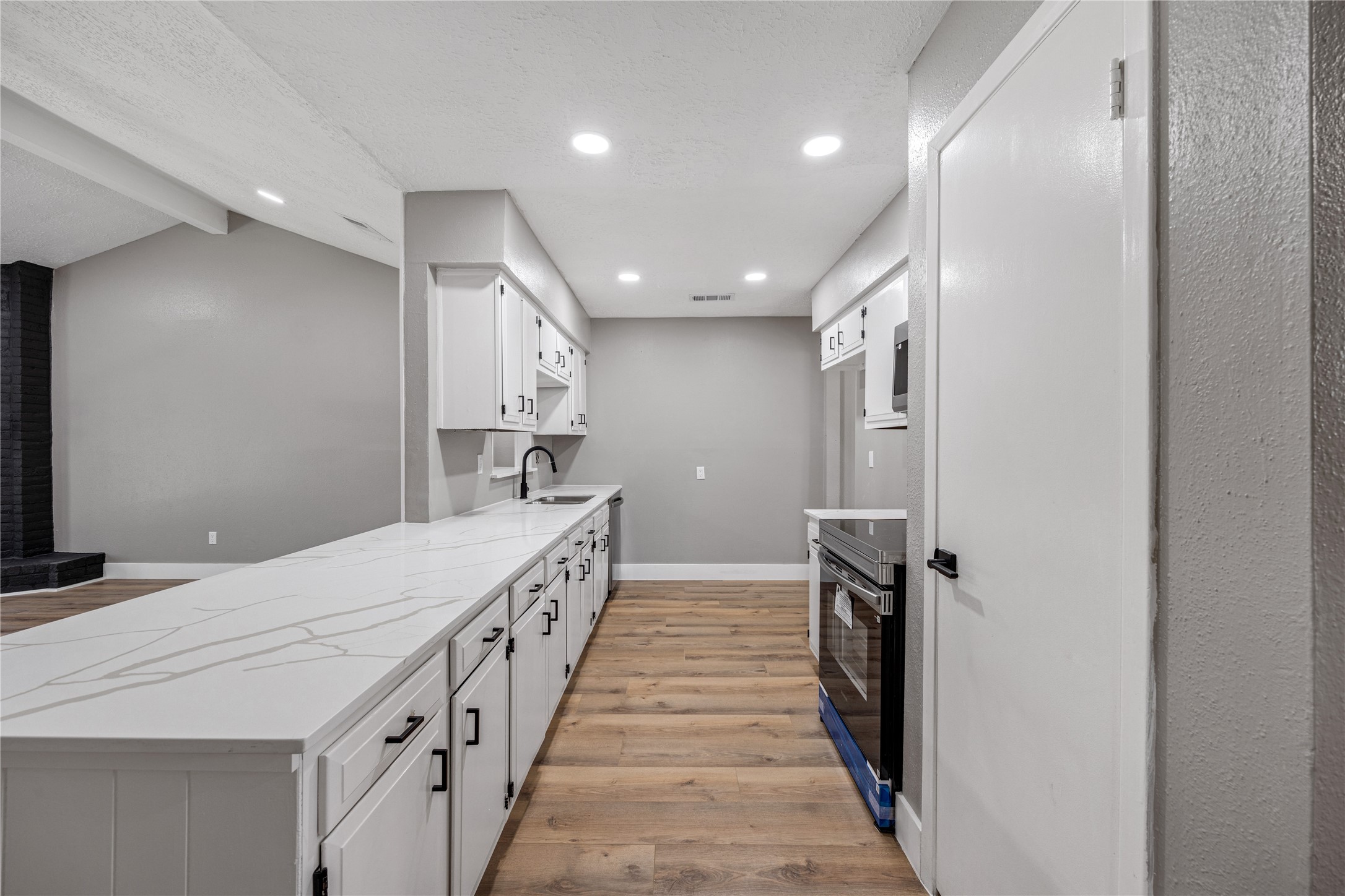 4515 Mossygate Drive Spring, TX 77373 - Photo 7 of 31 a kitchen with a sink and refrigerator