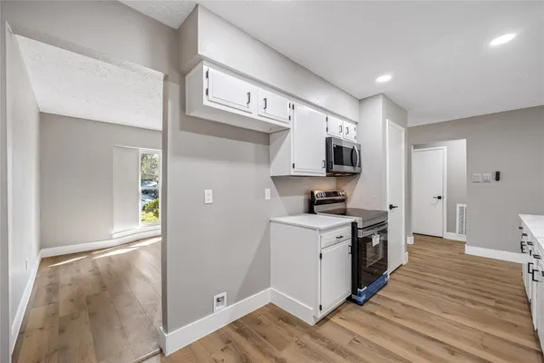 a kitchen with a stove a sink and a refrigerator