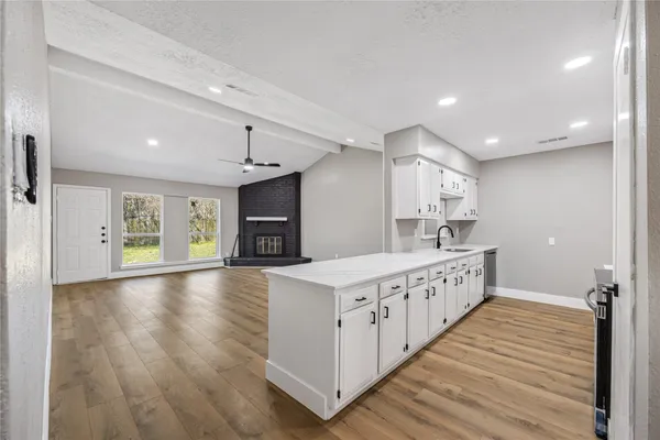 a kitchen with granite countertop a sink and a stove top oven