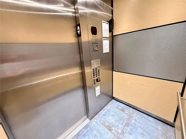 a kitchen with granite countertop a refrigerator and a sink