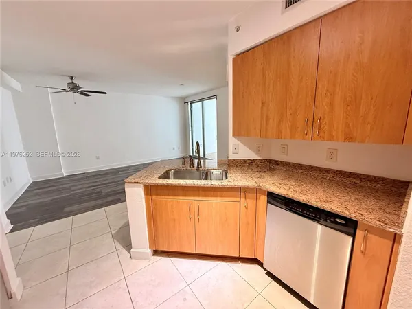 a kitchen with stainless steel appliances granite countertop a sink stove and microwave