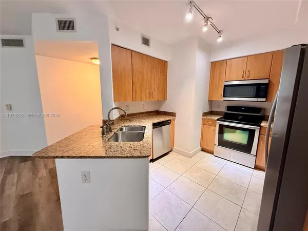 a view of a kitchen from the hallway