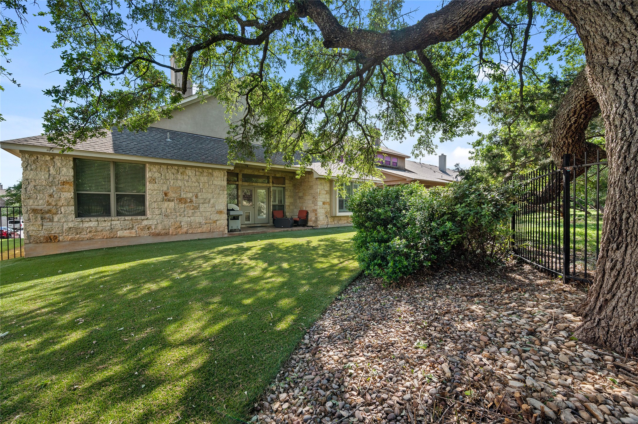 4512 Pyrenees Pass Bee Cave, TX 78738 - Photo 33 of 35 a front view of a house with garden