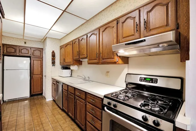 a kitchen with a stove and a refrigerator
